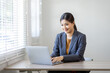 © David - Asian Business woman work on laptop for doing math finance on an office desk, tax, report, accounting, statistics, and analytical research concept