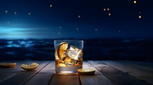 Glass With Water, Ice And Lemon On Wooden Table, Moon In The Sky In The Background. Glass Of Whiskey