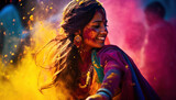 Indian woman dancing with colorful powder in holi festival