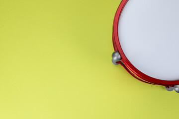 Drum on light green background, top view with space for text. Percussion musical instrument