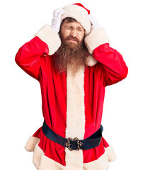 Sticker - Handsome young red head man with long beard wearing santa claus costume suffering from headache desperate and stressed because pain and migraine. hands on head.