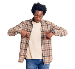 Sticker - Handsome african american man with afro hair wearing casual clothes and glasses pointing down with fingers showing advertisement, surprised face and open mouth