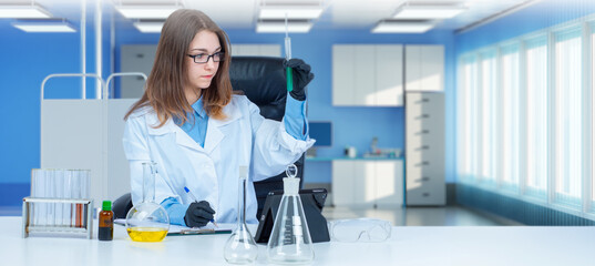 Poster - Woman biologist. Girl is sitting in laboratory. Biology college student at table. Biologist with test tube in hand. Biological research by clinic employee. Young scientist biologist.