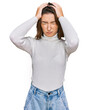 © Krakenimages.com - Young caucasian girl wearing casual clothes suffering from headache desperate and stressed because pain and migraine. hands on head.
