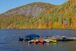 Colorful kayaks docked at a lake in the mountains in Autumn