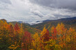 Storm clouds over the mountains covered in Fall color