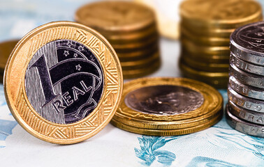 Wall Mural - details of banknotes of 100 reais from brazil, and brazilian coins, with selective focus, background image. Concept of investment in brazil or profit.