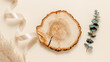 © Natureveryday - Wooden aesthetic product podium with ribbon, pampas grass and eucalyptus branch on beige background, top view. Aesthetic minimal showcase for product presentation, banner size