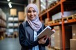 portrait of a smiling muslim female warehouse worker