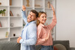 © Prostock-studio - Millennial couple dancing together in living room at home