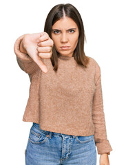 Canvas Print - Young beautiful woman wearing casual clothes looking unhappy and angry showing rejection and negative with thumbs down gesture. bad expression.