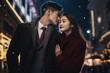 Generative AI portrait of young asian couple walking street wearing fashion clothes christmas decor big city
