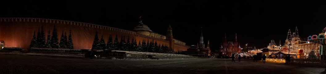 New Year's illumination of the red square. Christmas garlands on city lighting pylons. Ornaments above road. Night festive atmosphere. panorama