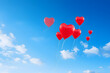canvas print picture - heart shaped balloon bouquet floating against a blue