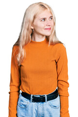 Canvas Print - Young caucasian woman wearing casual clothes smiling looking to the side and staring away thinking.