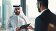 A Dubai businessman gives a clever presentation to a business partner