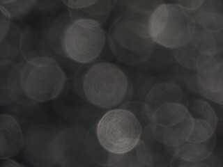 Wall Mural - Grey and white bokeh effect and purposely blurred view of sunlight reflection. Shiny background. Blurry background with photographic bokeh effect in beautiful neutral tones