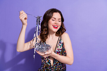 Poster - Photo of chic lady celebrate birthday event eating glitter shiny silver tinsels isolated on purple color background