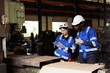 © EKKAPON - Engineer checking machine maintenance service with team working together teamwork in steel heavy factory