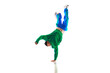 Fashionable portrait. Stylishly dressed man dancing in freestyle, breakdance style in motion against white studio background.