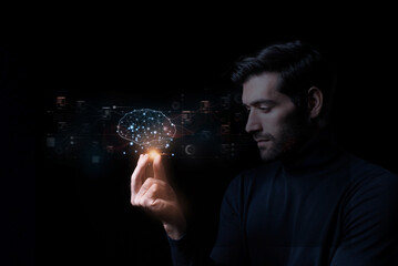 Close-up of a man's hand with a circuit hologram and a glowing cloud brain against a dark background. Hardware concepts related to artificial intelligence, machine learning, big data, and trade.