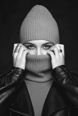 Wall Mural - black and white portrait of beautiful girl in balaclava and leather coat