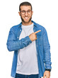 © Krakenimages.com - Young caucasian man wearing casual clothes pointing aside worried and nervous with forefinger, concerned and surprised expression