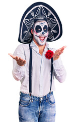 Poster - Man wearing day of the dead costume over background smiling cheerful offering hands giving assistance and acceptance.