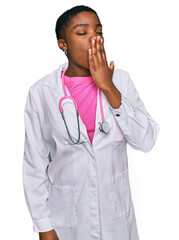 Canvas Print - Young african american woman wearing doctor uniform and stethoscope bored yawning tired covering mouth with hand. restless and sleepiness.