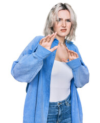 Sticker - Young blonde girl wearing casual clothes disgusted expression, displeased and fearful doing disgust face because aversion reaction. with hands raised