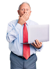 Sticker - Senior handsome grey-haired man wearing tie using laptop covering mouth with hand, shocked and afraid for mistake. surprised expression