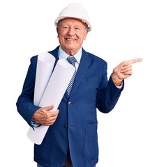 Poster - Senior handsome grey-haired man wearing architect hardhat holding blueprints smiling happy pointing with hand and finger to the side