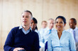 © STEEX/peopleimages.com - Audience, conference and business people in meeting for crowd, seminar and presentation in office. Corporate, company and happy men and woman sitting for workshop, training and team building