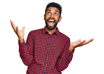 Canvas Print - Young african american man wearing casual clothes crazy and mad shouting and yelling with aggressive expression and arms raised. frustration concept.