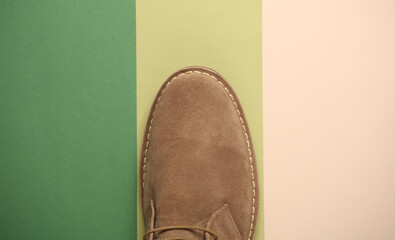 Suede desert boot on a colored background. Top view