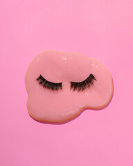 Wall Mural - Creative layout with false eyelashes and slime. Bright pink background. Visual beauty trend. Minimalistic fashion aesthetic still life. Fresh idea