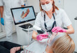 © Soloviova Liudmyla - Dentist female doctor in uniform using intraoral 3D dental scanner Machine for clear aligners production. Dental clinic patient visit modern medical ward. Health teeth care, medicare industry concept.