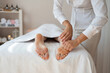 © ADDICTIVE STOCK - Crop hands of anonymous female therapist massaging foot of customer lying on bed to relieve pain by gently pressing pressure points at spa salon