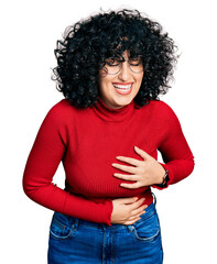 Sticker - Young middle east girl wearing casual clothes and glasses smiling and laughing hard out loud because funny crazy joke with hands on body.