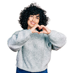 Canvas Print - Young middle east girl wearing casual clothes smiling in love doing heart symbol shape with hands. romantic concept.