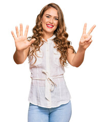 Sticker - Young blonde girl wearing casual clothes showing and pointing up with fingers number seven while smiling confident and happy.