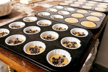 Tray With Uncooked Cupcakes On Table
