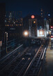 Subway train entering an elevated station at night in New York City
