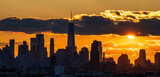 Fototapeta  - Sunset over the city silhouette on Manhattan New York 