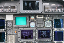Interior view of helicopter Agusta cockpit dashboard with buttons, switches, faders, displays