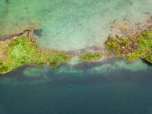 Aerial Drone Photo Of Small Islands On A Clear Blue Lake.
