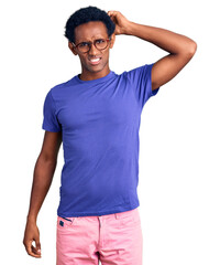 Wall Mural - African handsome man wearing casual clothes and glasses confuse and wonder about question. uncertain with doubt, thinking with hand on head. pensive concept.