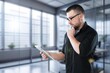 © BillionPhotos.com - Portrait of young businessman posing on the office