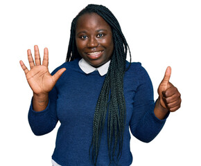 Wall Mural - Young black woman with braids wearing casual clothes showing and pointing up with fingers number six while smiling confident and happy.