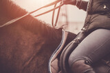 Fototapeta  - Atmospheric photo of a horse rider. Horse riding school. Equestrian theme.